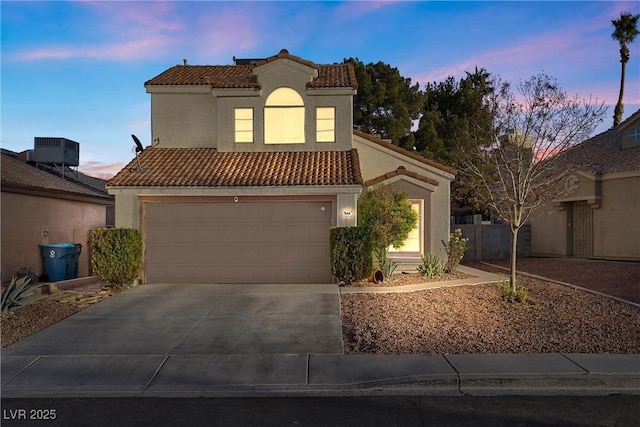 mediterranean / spanish home with central AC and a garage