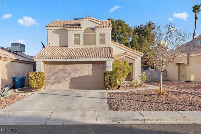 mediterranean / spanish-style house with a garage and central air condition unit