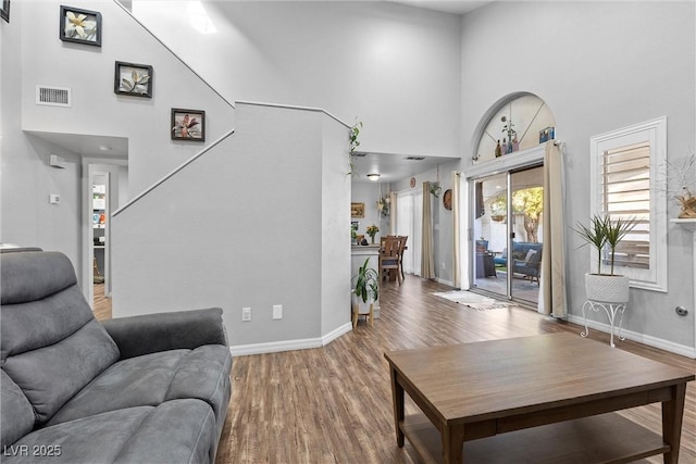 living room featuring a high ceiling and hardwood / wood-style floors