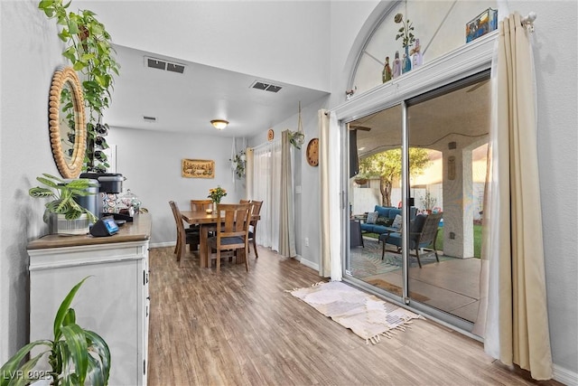 dining space with hardwood / wood-style floors