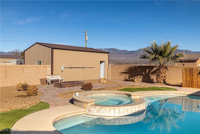 view of pool with a mountain view and an in ground hot tub