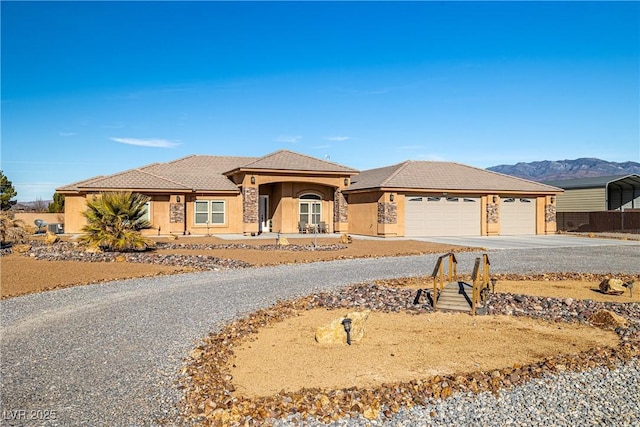 view of front of home with a mountain view and a garage