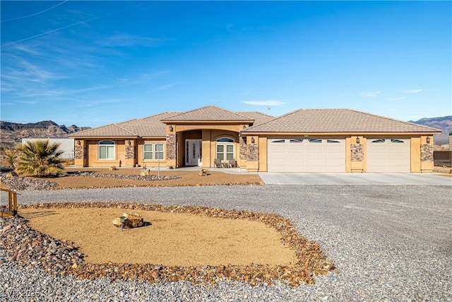 view of front of home featuring a mountain view and a garage