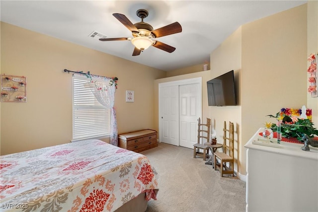 bedroom with light carpet, a closet, and ceiling fan