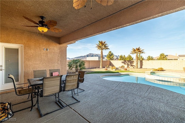 view of pool featuring a patio area, an in ground hot tub, and a mountain view