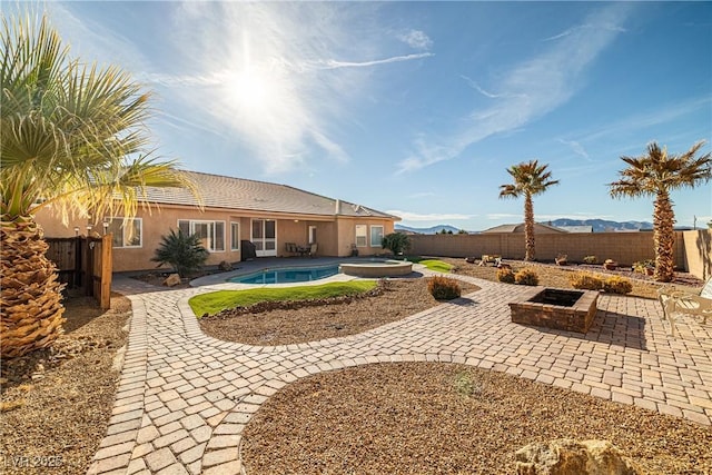 view of yard featuring a mountain view, a fenced in pool, and a patio area