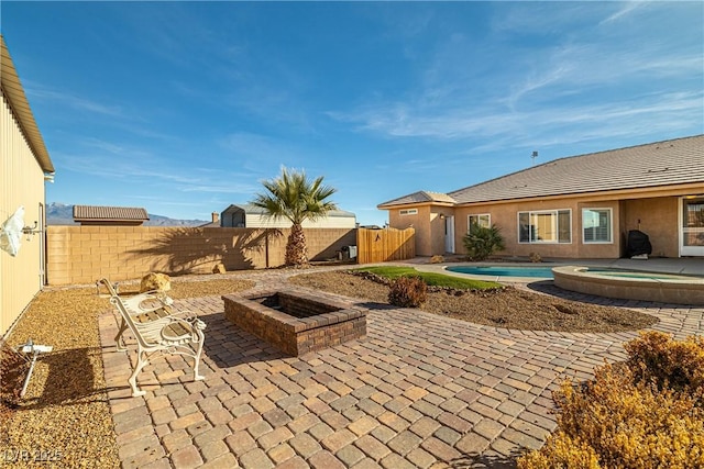 view of patio featuring a fire pit and a fenced in pool