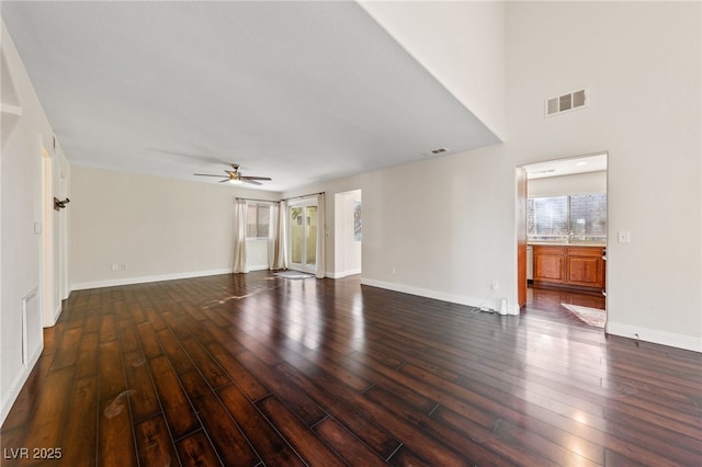 interior space with ceiling fan and dark hardwood / wood-style flooring