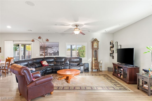 living room featuring ceiling fan and light hardwood / wood-style floors