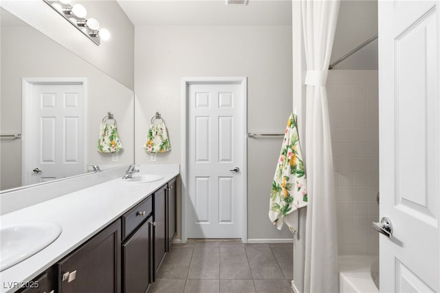 bathroom with shower / bath combination with curtain, vanity, and tile patterned floors