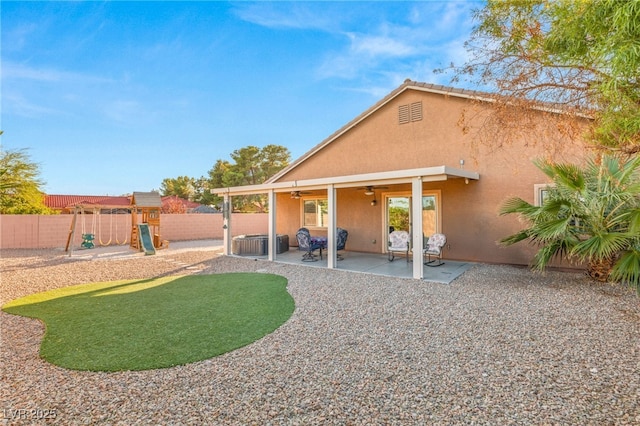 rear view of house with a playground, a patio area, ceiling fan, and cooling unit