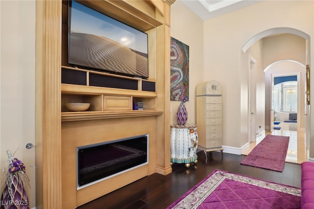 interior space with built in shelves and dark hardwood / wood-style flooring