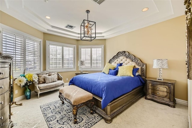 carpeted bedroom featuring a raised ceiling