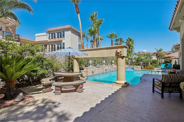 view of swimming pool with a patio area