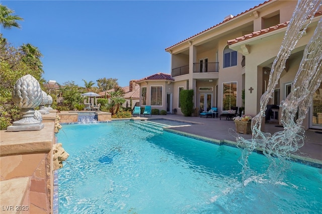 view of pool featuring a patio area and pool water feature