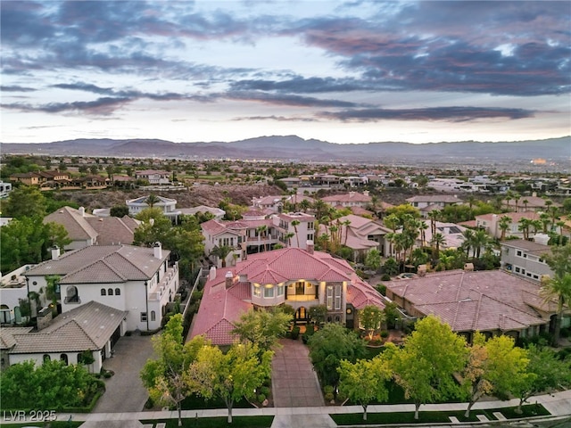 aerial view at dusk featuring a mountain view