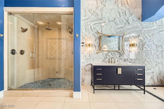 bathroom featuring tile patterned flooring, vanity, and a shower with door