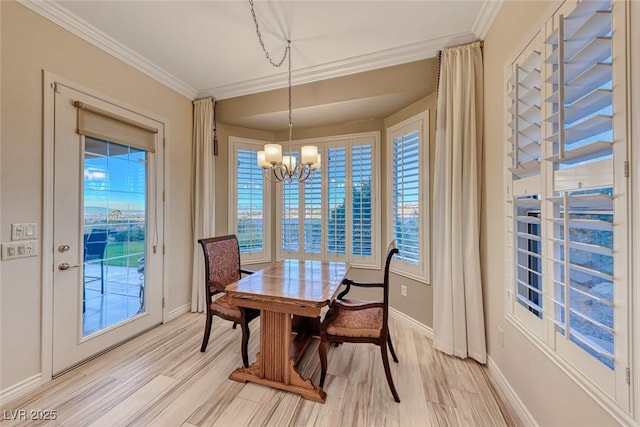 dining room with a notable chandelier, light hardwood / wood-style floors, and ornamental molding