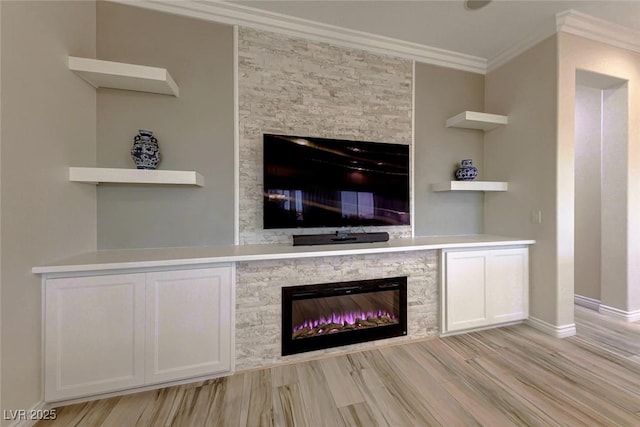 unfurnished living room with a fireplace, light hardwood / wood-style flooring, and ornamental molding