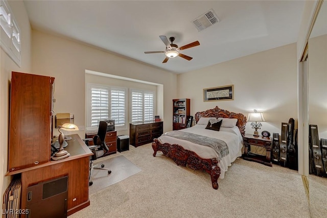 carpeted bedroom featuring ceiling fan and a closet