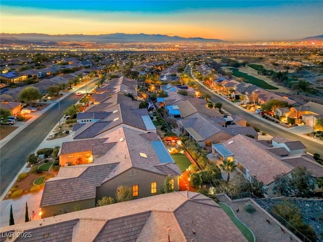 aerial view at dusk featuring a mountain view