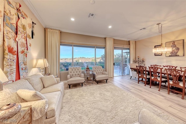 living room featuring light wood-type flooring and crown molding