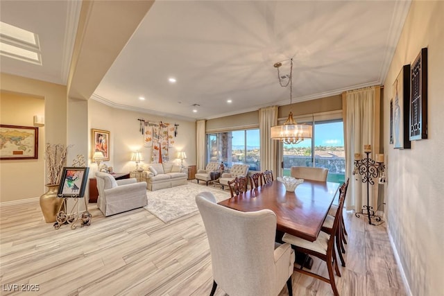 dining area with light wood-type flooring and crown molding