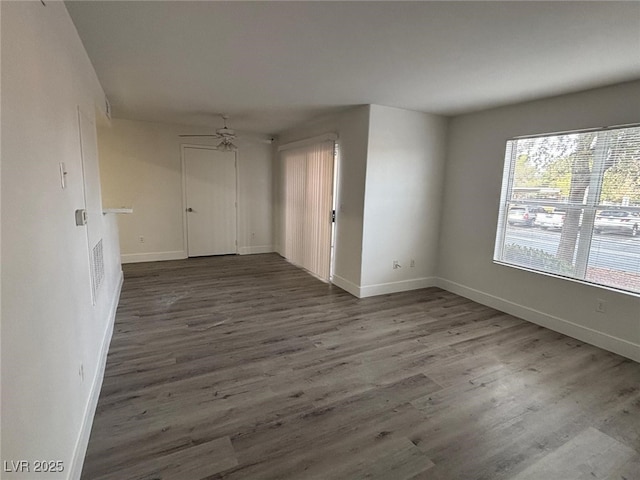 unfurnished room with dark hardwood / wood-style floors and ceiling fan