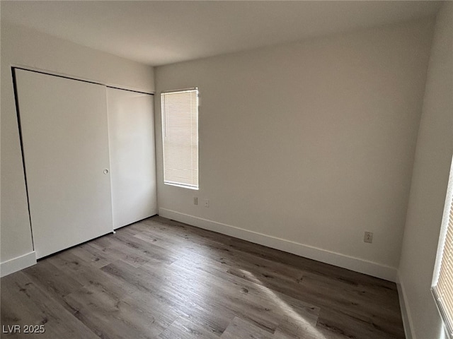 unfurnished bedroom with light hardwood / wood-style floors and a closet