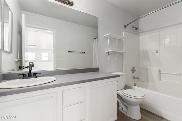 full bathroom featuring vanity, hardwood / wood-style flooring, toilet, and shower / washtub combination