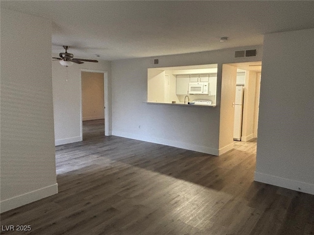 empty room featuring dark hardwood / wood-style flooring and ceiling fan