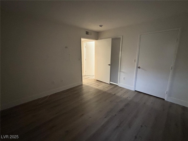 unfurnished bedroom with hardwood / wood-style flooring