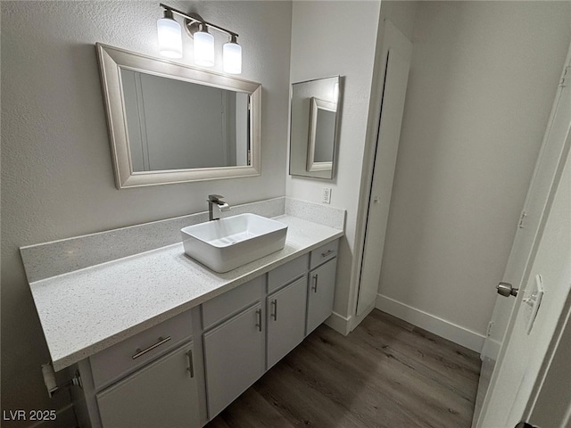 bathroom with vanity and wood-type flooring