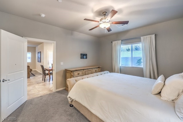 bedroom with light carpet and ceiling fan