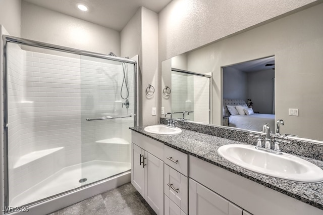 bathroom featuring vanity and a shower with door