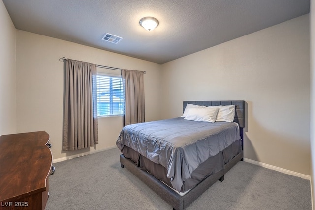 bedroom featuring a textured ceiling and carpet