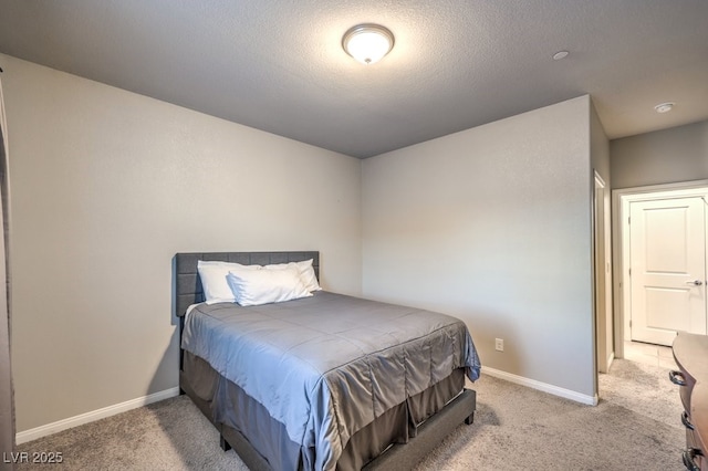 carpeted bedroom featuring a textured ceiling