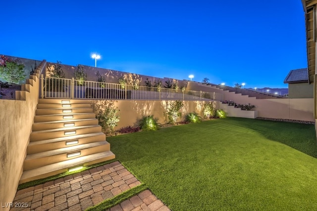 view of yard at dusk