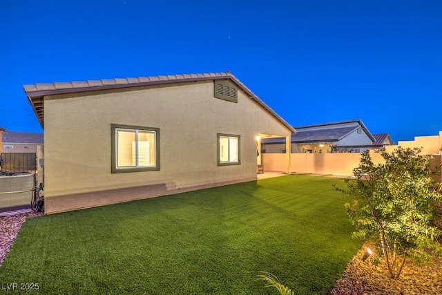 rear view of property featuring a lawn