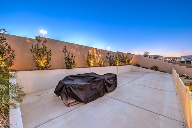 view of patio terrace at dusk