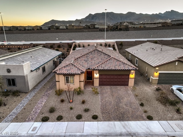 aerial view at dusk featuring a mountain view