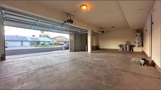 garage featuring a garage door opener and water heater