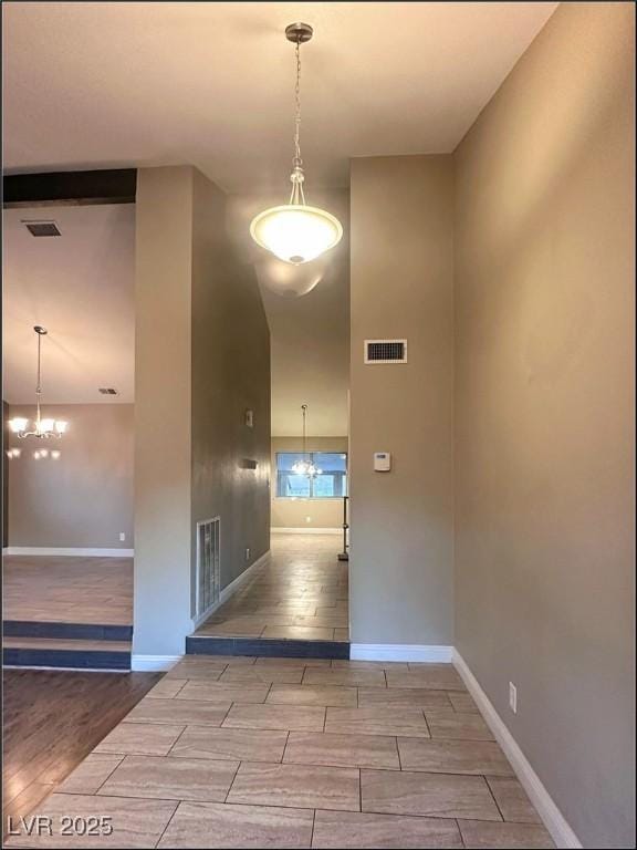 corridor with a notable chandelier