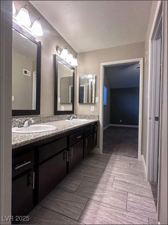 bathroom featuring vanity and a textured ceiling