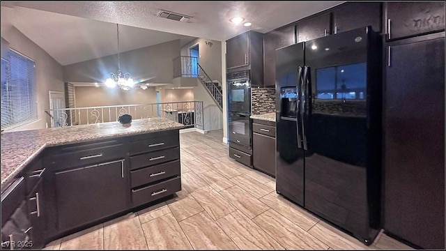 kitchen with backsplash, vaulted ceiling, black appliances, decorative light fixtures, and an inviting chandelier