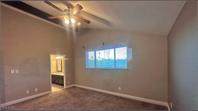 unfurnished bedroom featuring light carpet, connected bathroom, ceiling fan, and lofted ceiling