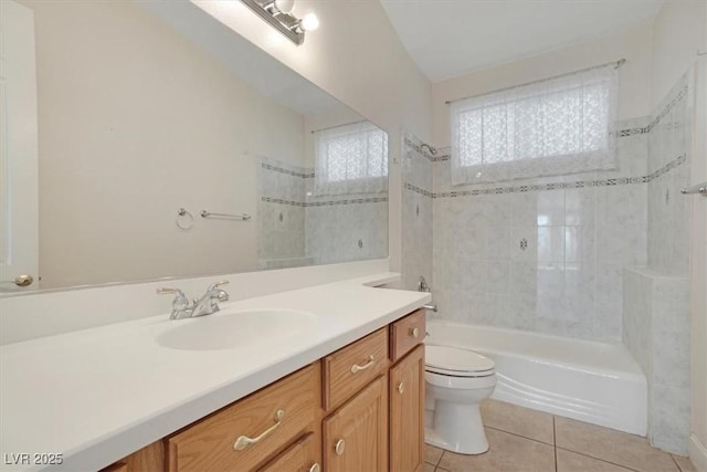 full bathroom featuring tile patterned floors, vanity, toilet, and tiled shower / bath