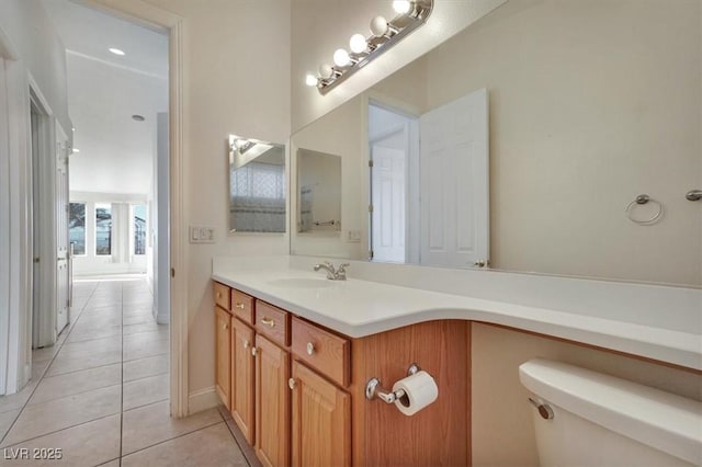 bathroom with tile patterned flooring, vanity, and toilet