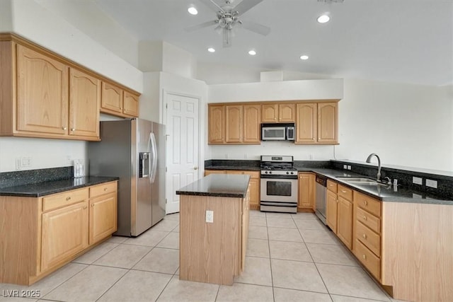 kitchen with a center island, sink, ceiling fan, light tile patterned floors, and appliances with stainless steel finishes