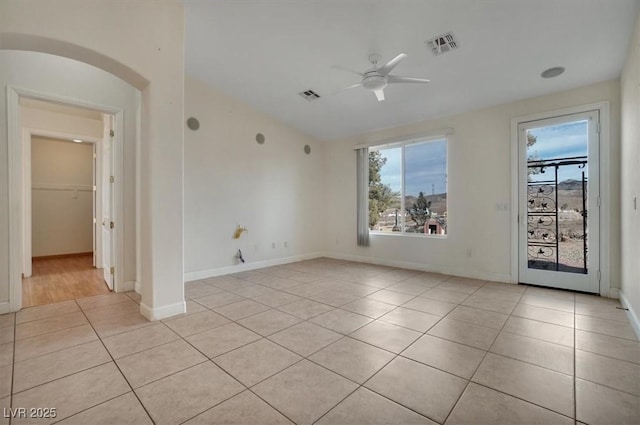 unfurnished room with ceiling fan and light tile patterned flooring